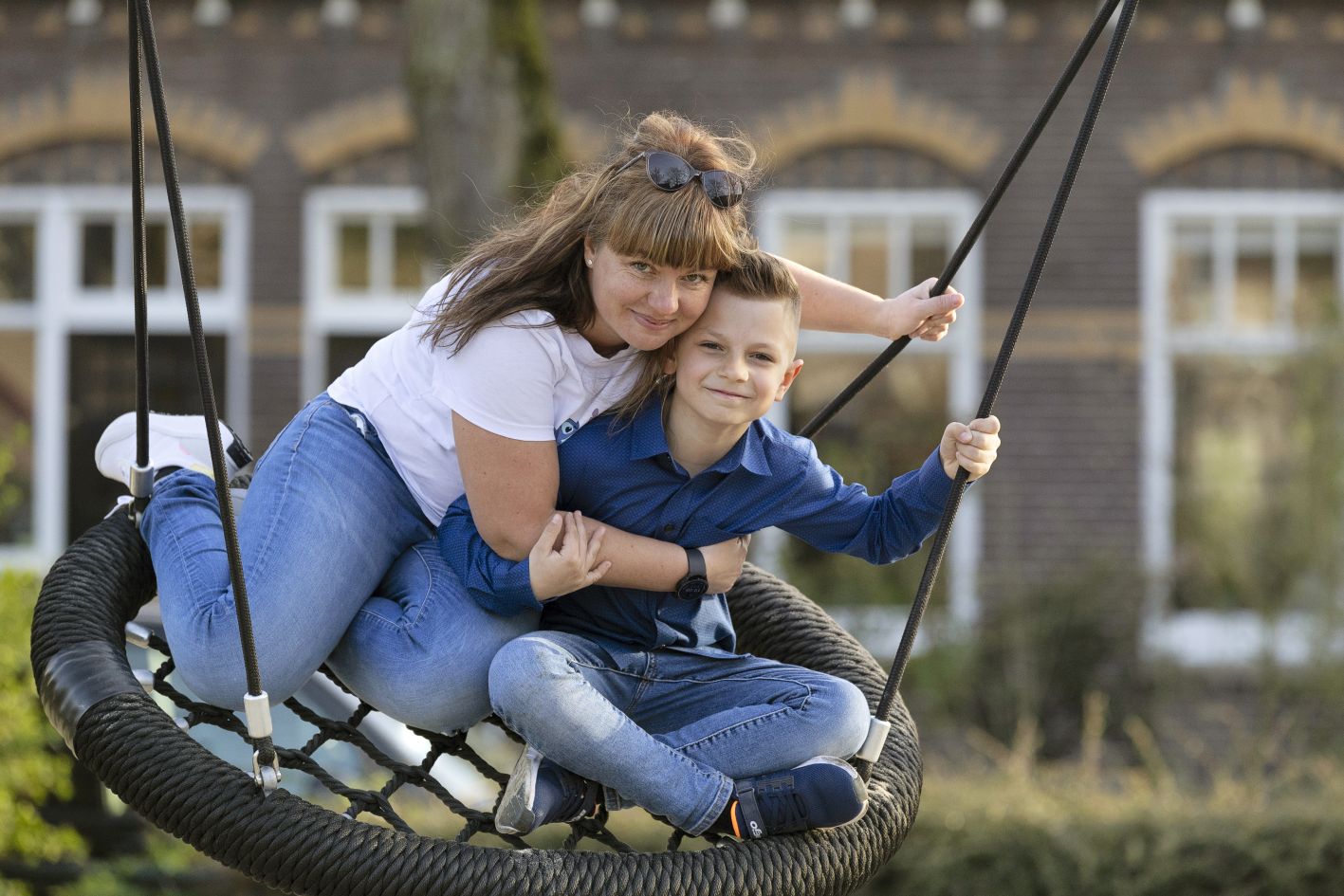 foto van een moeder en kind op een schommel