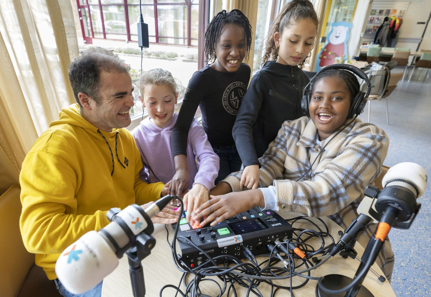 Foto kinderwerker met vier kinderen zijn podcast aan het maken